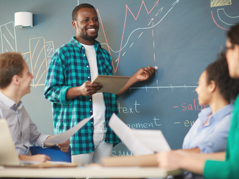 male small business owner shares low cost marketing strategies with employees