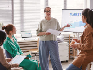 a small business owner shows her staff examples of marketing strategies for small business