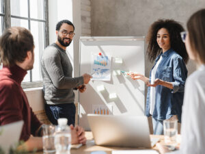 Small business owner plans local marketing strategies with staff