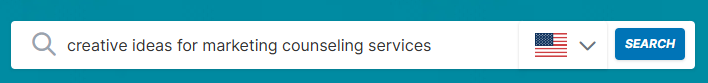 Search bar with "creative ideas for marketing counseling services," keyword difficulty info, and an American flag language selector.