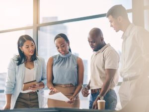 Small business owner and employees discuss where to invest in marketing