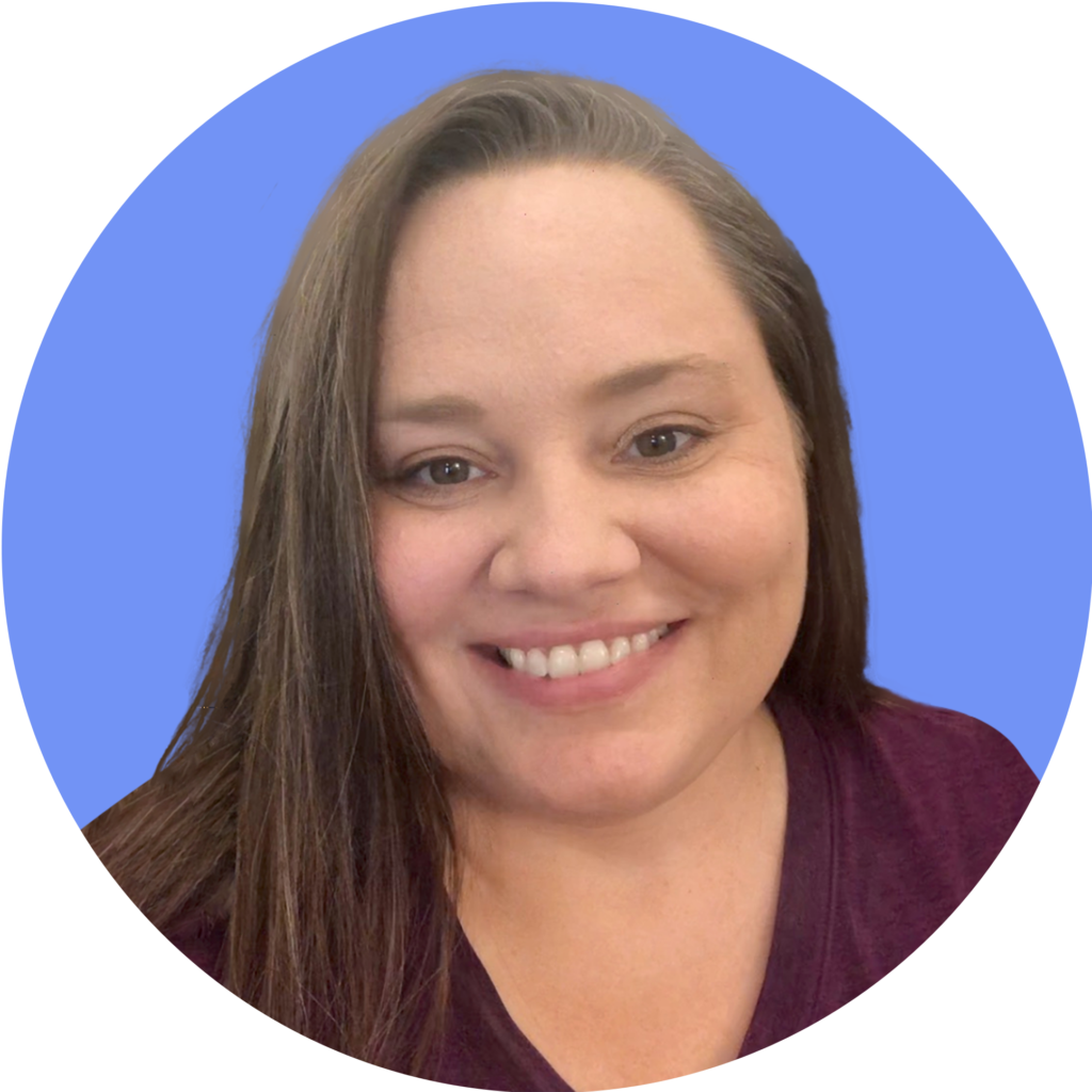 Woman with long brown hair smiling, wearing a maroon shirt; perfect for your small business website strategy.