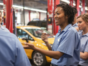 a team of employees in an auto repair business discussing auto repair marketing