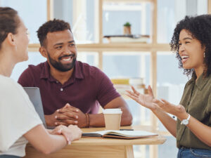 a small business owner receiving small business reviews from customers during a meeting
