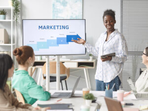 small business owner and employees discuss low cost digital marketing in a business meeting