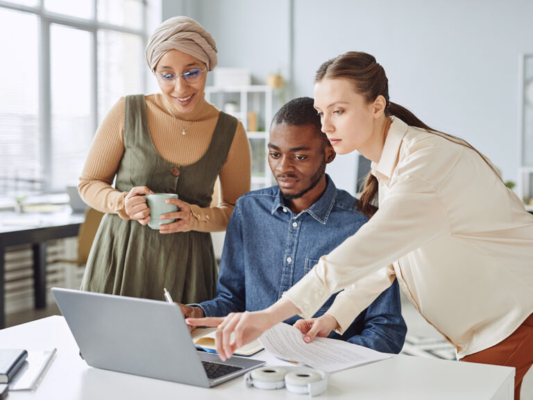 Small business team looking up marketing budget for a startup via a laptop