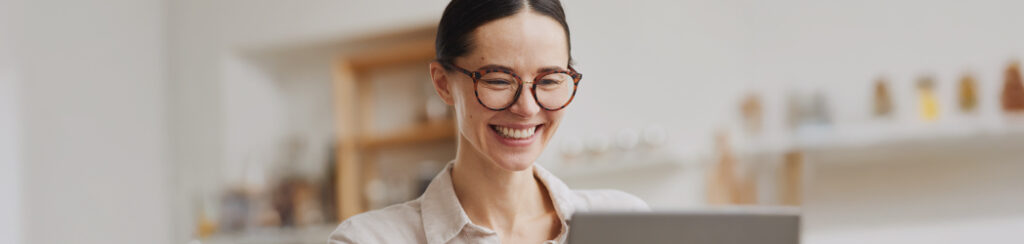A woman explores blogging as a marketing tool via her laptop.