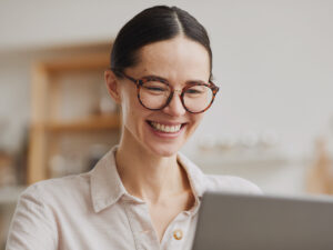 She researches blogging as a marketing tool in a bright indoor setting.