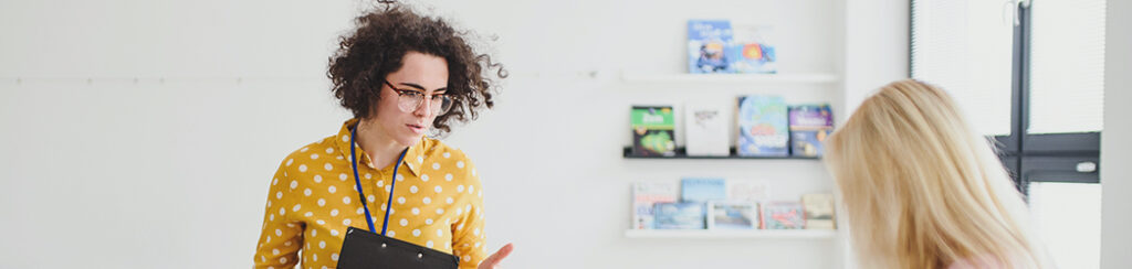 A woman discusses affordable SEO marketing in a bright, modern room.