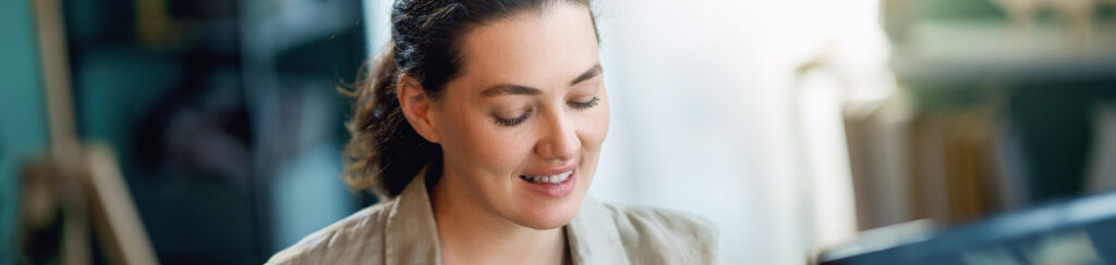 Small business owner researches on google search vs display ads via her laptop