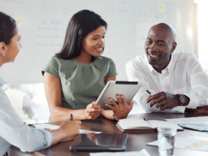 Three people in business attire discuss how long does local SEO take.