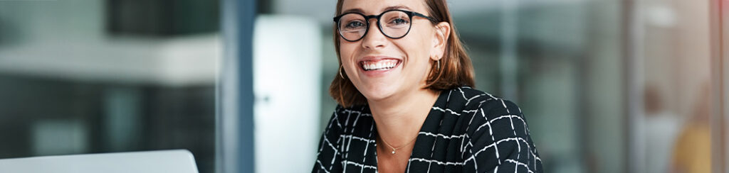 Woman with glasses pondering “should I post to my blog every day?”