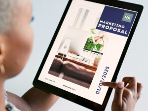 Small business owner holds a tablet displaying a local business marketing proposal on the screen