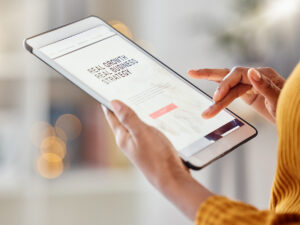 Person evaluating how to improve small business website featured on tablet