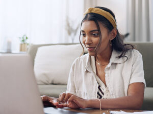 Woman wearing a headband researching local SERPs in her home