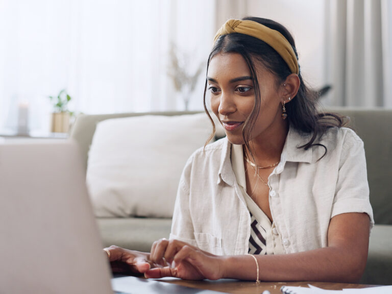 Woman wearing a headband researching local SERPs in her home
