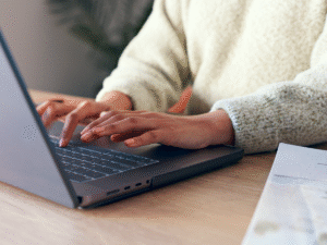 woman typing on laptop in office showing follow up strategy for managing sales leads and communication