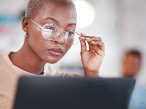 woman intently viewing laptop screen analyzing a customer journey map for website visitor behavior and conversions.