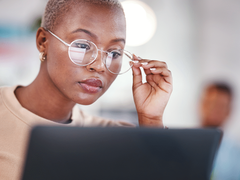 woman intently viewing laptop screen analyzing a customer journey map for website visitor behavior and conversions.