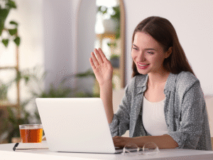 Customer smiling while browsing a laptop, showing how internal linking improves website navigation