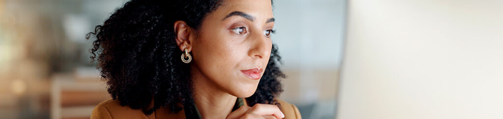 Woman displays search behavior and intent while looking data up on her computer