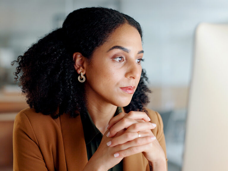 Woman analyzes data on her computer screen, displaying search behavior and intent