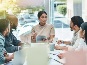 A woman leads a meeting on a marketing system