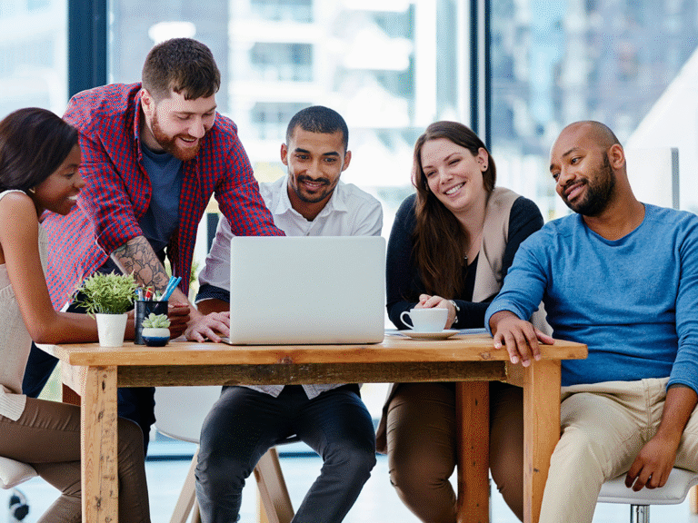 Group of people using a laptop discussing website navigation and website structure improvements.