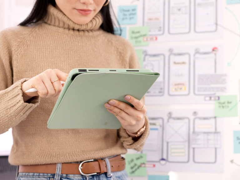 Business owner viewing local search results and ratings enhanced by local schema markup on a tablet.