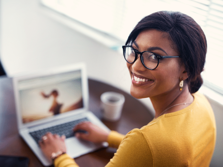 Businesswoman working on brand consistency for her website while using a laptop.