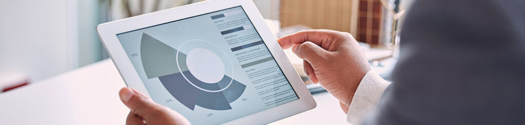 Person holding a tablet displaying an organic search data visualization chart with labeled percentages and sections.
