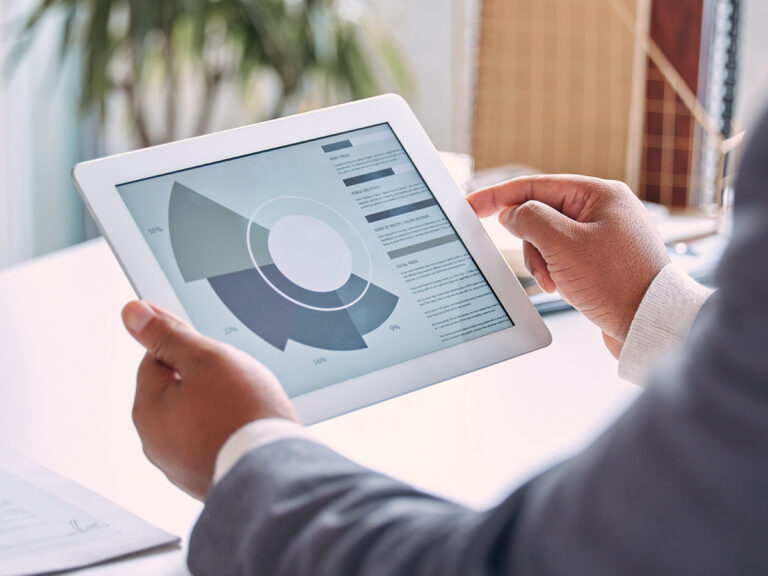 Person holding a tablet displaying organic search data on a circular chart with segmented percentages.