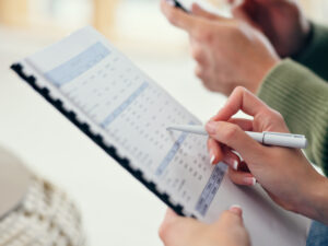 Person reviewing a budget document to ensure low budget marketing for their small business