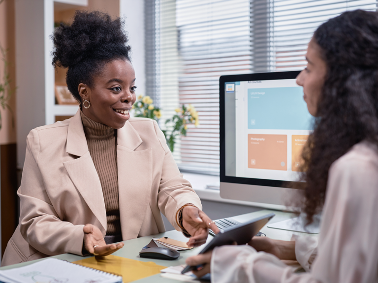 Small business owner discussing seasonal SEO strategy with a marketing consultant.